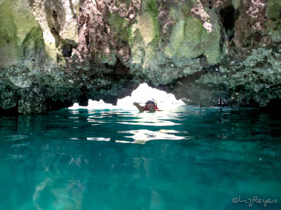 Me swimming my way through the narrow cave entrance